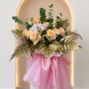 An elegant bouquet of peach roses, white hydrangea, and green foliage.