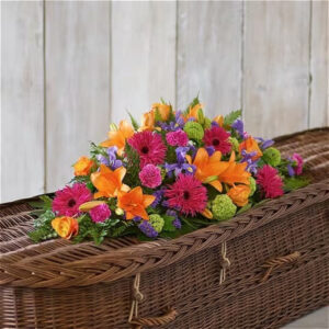 Vibrant Casket Spray, a handcrafted funeral flowers by Flowers by Kerry Mac Manchester florist
