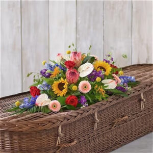 Natural Vibrance casket spray, a handcrafted funeral flowers by Flowers by Kerry Mac Manchester florist